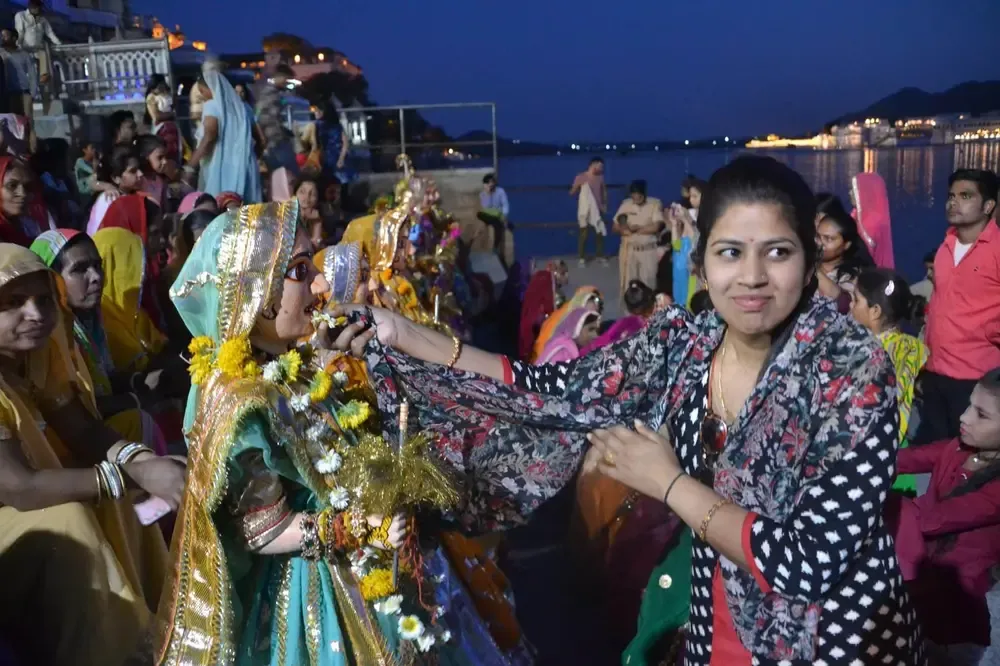 Mujer hindú adorando a la diosa a orillas del lago Pichola en Udaipur